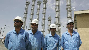 Iranian employees pose for a picture at the newly opened heavy water plant in Arak, 320 kms south of Tehran, 26 August 2006. (File photo: AFP)