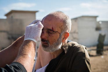 An elderly Mosul resident is treated for shrapnel wounds to his head at an Iraqi Special Forces 2nd division open air field clinic in the Samah neighbourhood of Mosul on November 17, 2016. Iraqi forces have broken into jihadist-held Mosul and recaptured neighbourhoods inside the city, but a month into their offensive, there are still weeks or more of potentially heavy fighting ahead. The medical point saw a spike in patients today with dozens coming through in a few hours among them several children and 5 fatalities. Odd ANDERSEN / AFP
