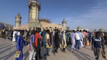 Members of the Mouride Brotherhood, a large Sufi order largely present in Senegal, queue to enter the Great Mosque in Touba on November 19, 2016 