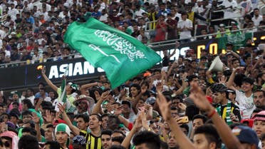 Saudi fans wave the national flag and chant during the 2018 World Cup qualifying football match between Saudi Arabia and United Arab Emirates at the King Abdullah Sports City stadium in Jeddah on October 11, 2016.  STRINGER / AFP