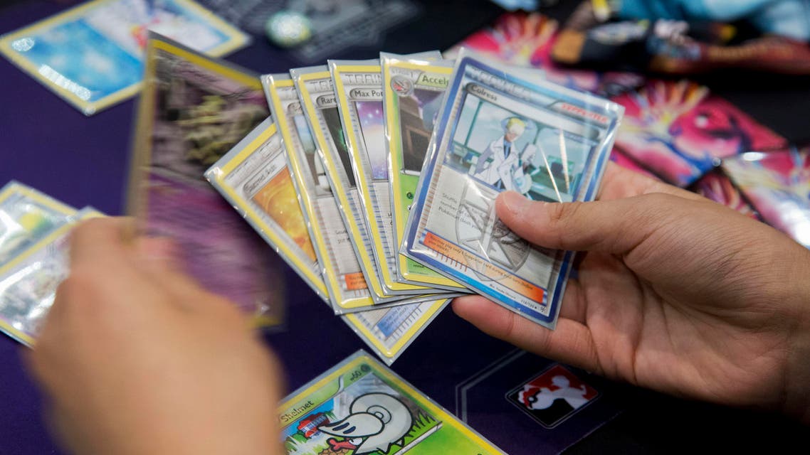 Competitor Jeffrey Chang from Washington state, reviews his hand, as he competes for a last chance qualifier spot in the Pokémon trading card game for the 2014 Pokémon World Championships in Washington, Friday, Aug. 15, 2014. (AP Photo/Manuel Balce Ceneta)