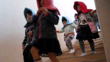 School children wearing padded hoods to protect them from falling debris take part in a tsunami simulation drill ahead of World Tsunami Awareness Day at Futaba elementary school in Choshi, Chiba Prefecture, Japan, November 4, 2016