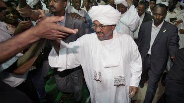 Sudan's president Omar al-Bashir, center, is congratulated by his supporters at the ruling party headquarters in Khartoum, Sudan, Monday, April 26, 2010. Sudan's president won another term in office Monday with a comfortable majority in elections marred by boycotts and fraud allegations, becoming the first head-of-state to be re-elected while facing an international arrest warrant for war crimes. (AP