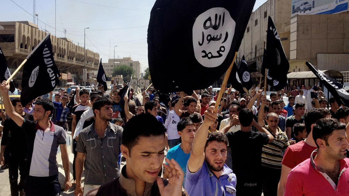 In this June 16, 2014. file photo, demonstrators chant pro-Islamic State group slogans as they carry the group's flags in front of the provincial government headquarters in Mosul, Iraq. AP