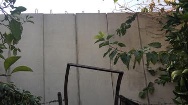 A picture taken on November 21, 2016 shows a building structure at the Palestinian Ain al-Hilweh refugee camp, near the Lebanese southern coastal city of Sidon. Lebanon is building a wall near the country's largest Palestinian refugee camp to prevent jihadist infiltrations, a military source said, as some denounced a "wall of shame" like Israel's separation wall. (AFP)