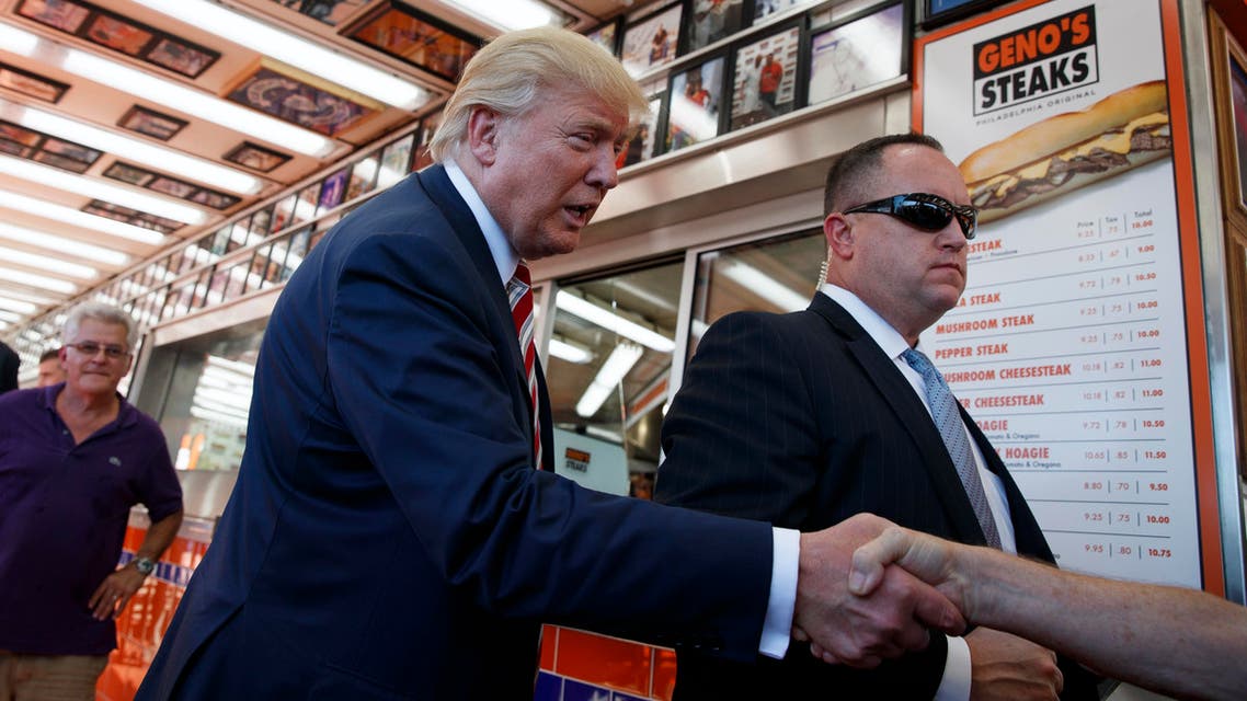 Republican presidential candidate Donald Trump shakes hands with customers during a visit to Geno's Steaks, Thursday, Sept. 22, 2016, in Philadelphia. (AP
