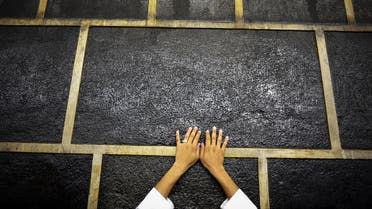A muslim pilgrim touches Islam's holiest shrine, the Kaaba, at the Grand Mosque in the Saudi holy city of Mecca, late on September 21, 2015. The annual hajj pilgrimage begins on September 22, and more than a million faithful have already flocked to Saudi Arabia in preparation for what will for many be the highlight of their spiritual lives. AFP PHOTO / MOHAMMED AL-SHAIKH  MOHAMMED AL-SHAIKH / AFP