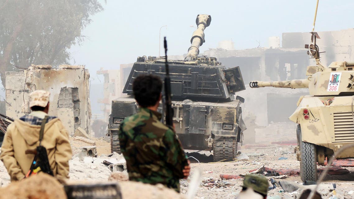 Forces loyal to Libya's Government of National Accord (GNA) stand behind a self-propelled howitzer cannon as they hold a position in Sirte's Al-Giza Al-Bahriya district on November 21, 2016. (AFP)