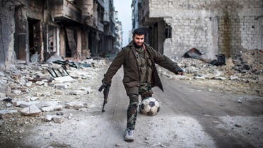 A Syrian rebel plays football in the Saif al-Dawlah neighborhood of Aleppo, Syria, Wednesday, Jan. 2, 2013. AP