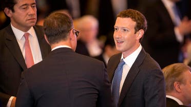 Facebook CEO Mark Zuckerberg, right, talks with fellow participants after the opening ceremony of the China Development Forum at the Diaoyutai State Guesthouse in Beijing, Sunday, March 20, 2016. (File photo: AP)