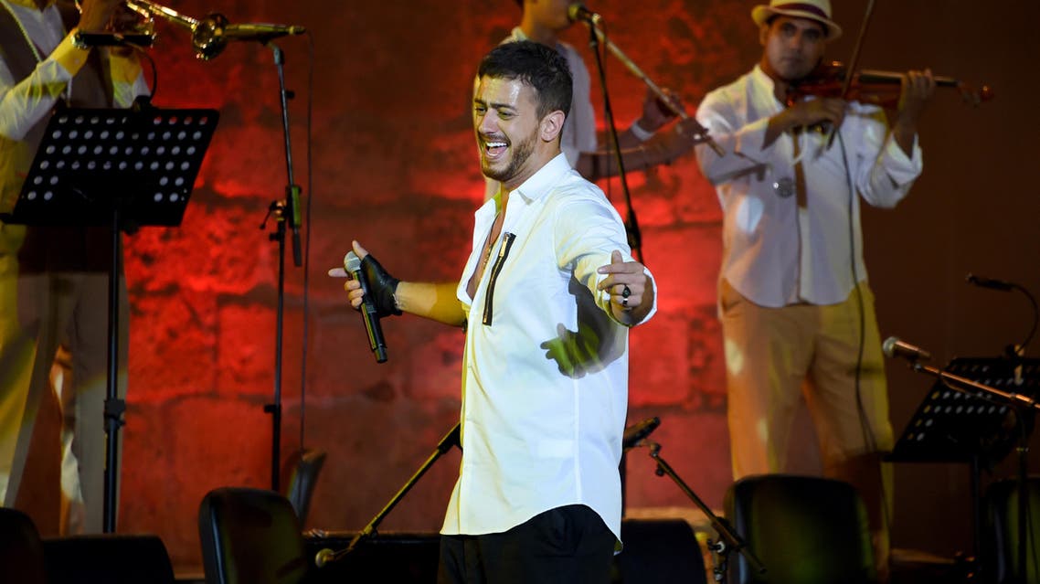 Morocco singer Saad Lamjarred performs with Ukrainian Orchestra Symphonic at the opening of the Carthage Festival on July 30, 2016 at the romain theatre of carthage near Tunis.  FETHI BELAID / AFP