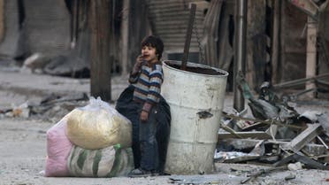 A boy stands amid the damage in the rebel-held besieged al-Shaar neighborhood of Aleppo, Syria November 23, 2016. REUTERS/Abdalrhman Ismail