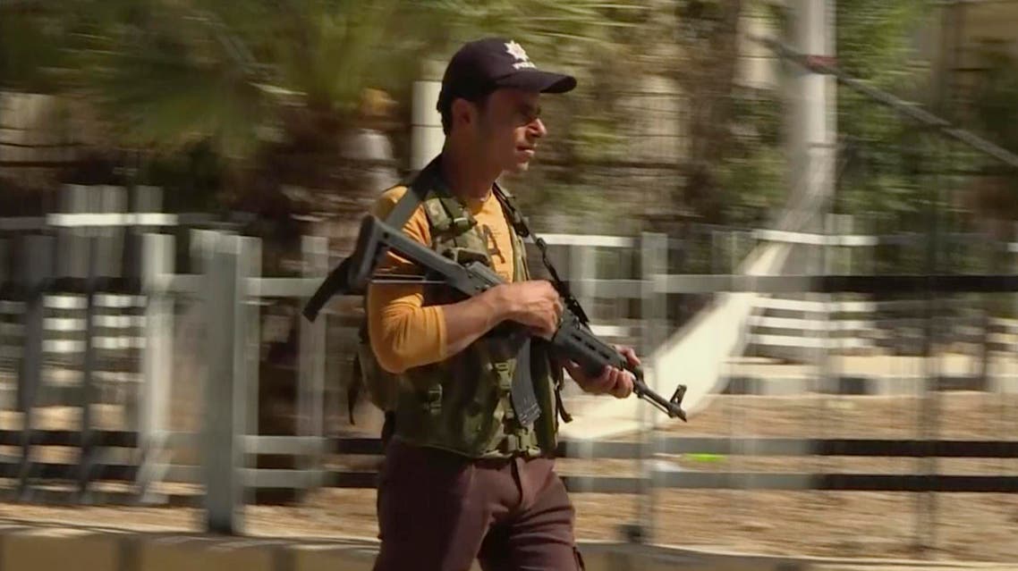In this image made from video posted online by Qasioun News Agency, a member of a Turkish-backed Syrian opposition force patrols in Dabiq, Syria, Sunday, Oct. 16, 2016. AP