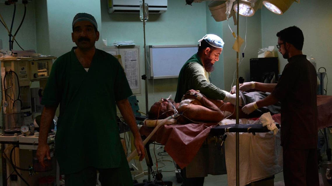 Pakistani doctors treat a villager injured by Indian firing, at a local hospital in Muzaffarabad, capital of Pakistani Kashmir, Wednesday, Nov. 23, 2016. Artillery fire and shelling from India targeted several villages and struck a passenger bus near the dividing line in the disputed region of Kashmir on Wednesday, killing many civilians wounding more than a dozen others, the Pakistani military and officials said. (AP Photo/M.D. Mughal)