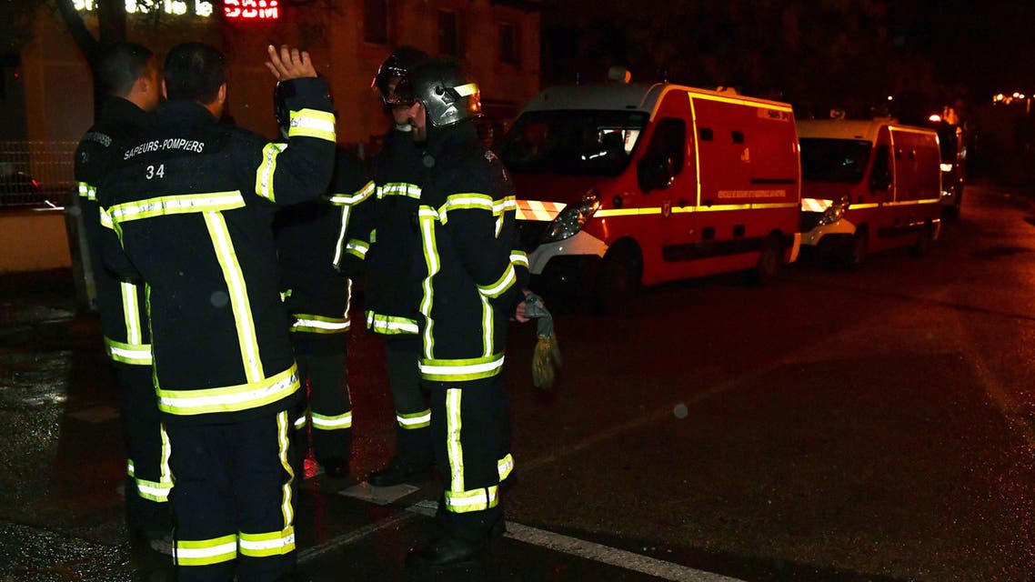 Firemen stand on a road near a retirement home for monks in Montferrier-sur-Lez, southern France, early on November 25, 2016, after an armed man bursted in the home killing a woman with a knife. Armed police were hunting the man inside the home, which is home to around 70 men and women who have served as missionaries in Africa. Authorities said it was a "criminal act".