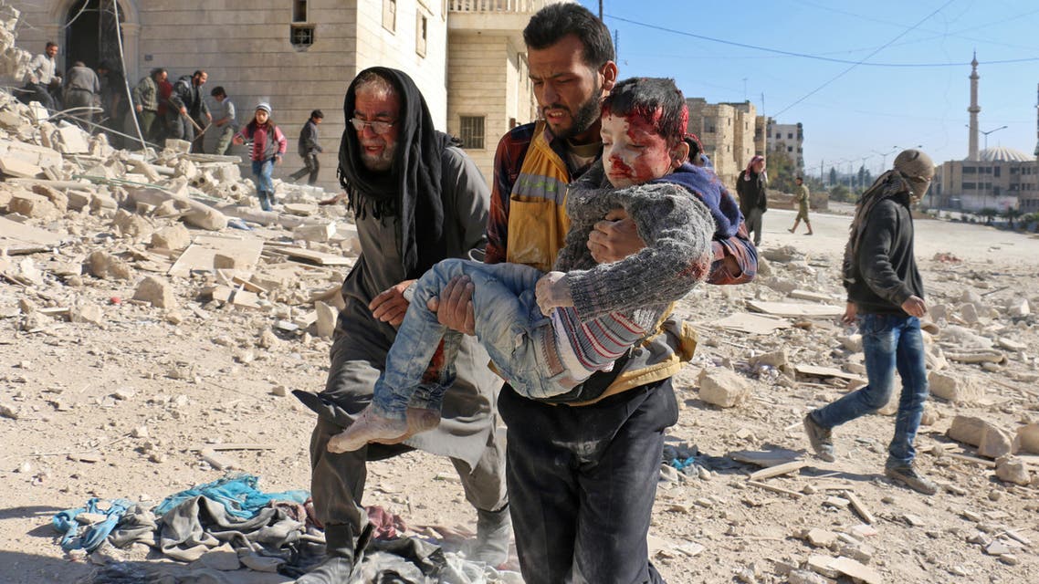 A Syrian civil defense volunteer, known as the White Helmets, carries a boy rescued from the rubble following a reported barrel bomb attack on the Bab al-Nairab neighborhood of Aleppo on November 24, 2016. (AFP)
