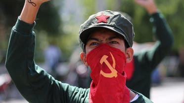 A Filipino activist uses a cloth printed with the hammer and sickle symbol to cover his face during a rally near the Malacanang presidential palace in Manila, Philippines Monday, Aug. 22, 2016. Philippine President Rodrigo Duterte recently reimposed an indefinite cease-fire after communist guerrillas declared their own truce as both sides resume talks aimed at ending one of Asia's longest-running rebellions. (AP Photo/Aaron Favila)