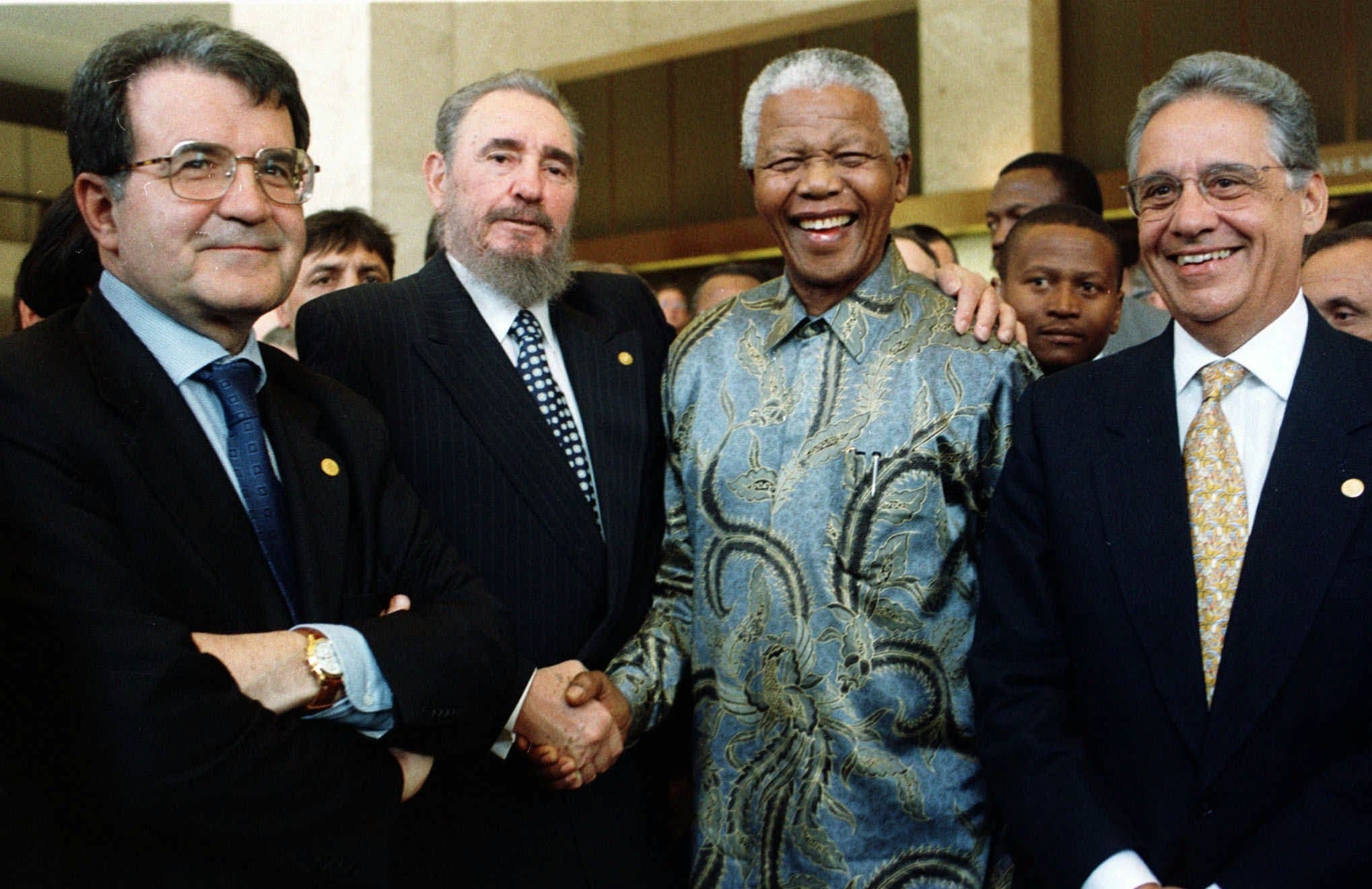 Cuban President Fidel Castro, second left, shakes the hand of a laughing Nelson Mandela, as Italian Prime Minister Romano Prodi, 1st left, and Brazilian President Fernando Henrique Cardoso, right, look on at the 50th anniversary ceremony of the GATT Agreement, during the ministerial conference of the WTO (World Trade Organisation) held in Geneva,Tuesday May 19, 1998. (AP)