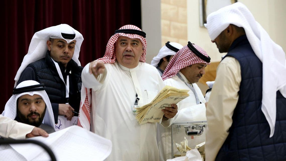 A Kuwaiti judge (C) and his aides count the ballots at a polling station at the end of the vote in the Sabah al-Salem district on the outskirts of Kuwait city. (AFP)