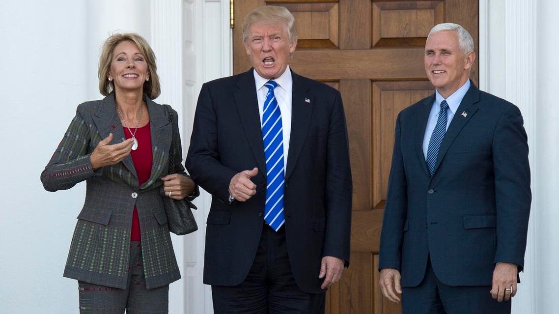 his file photo taken on November 19, 2016 shows US President-elect Donald Trump and Vice President-elect Mike Pence as they meet with businesswoman Betsy DeVos at Trump National Golf Club in Bedminster, New Jersey. President-elect Donald Trump intends to name Betsy DeVos as his nominee for Education Secretary, according to CNN. Don EMMERT / AFP