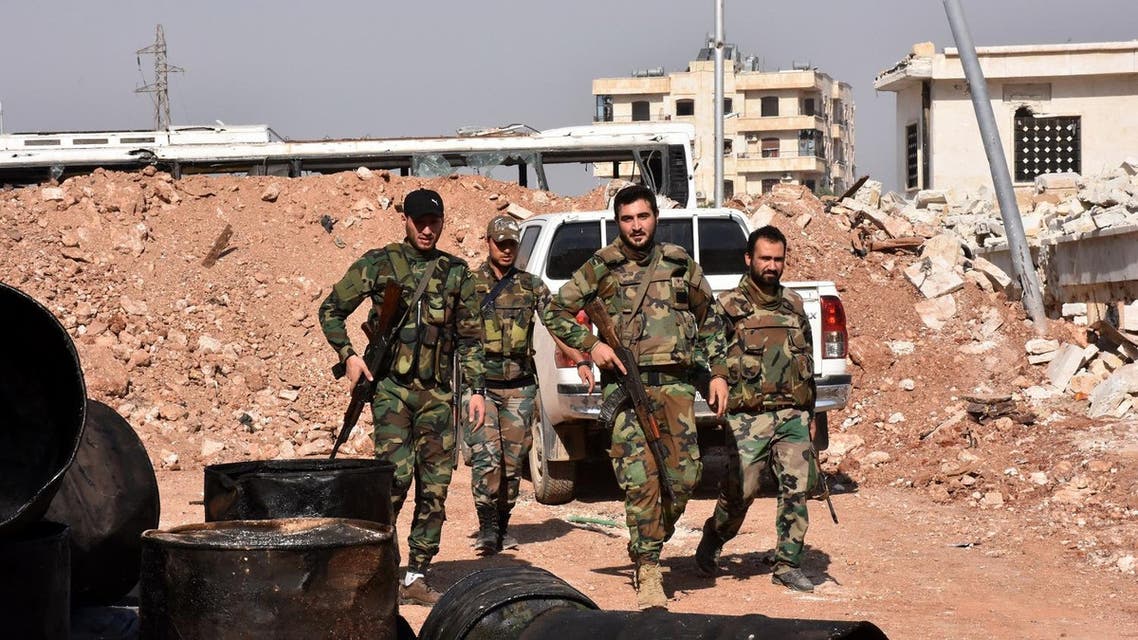 Syrian pro-government forces walk around in the village of Minyan, west of Aleppo. (AFP)