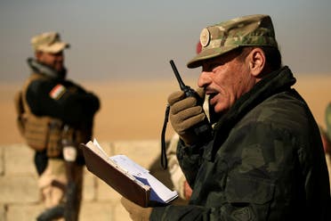 Nineveh Operations Commander Major General Najm al-Jubbouri uses a handheld radio during an operation against Islamic State militants southeast of Mosul, Iraq November 26, 2016. Picture taken November 26, 2016. REUTERS