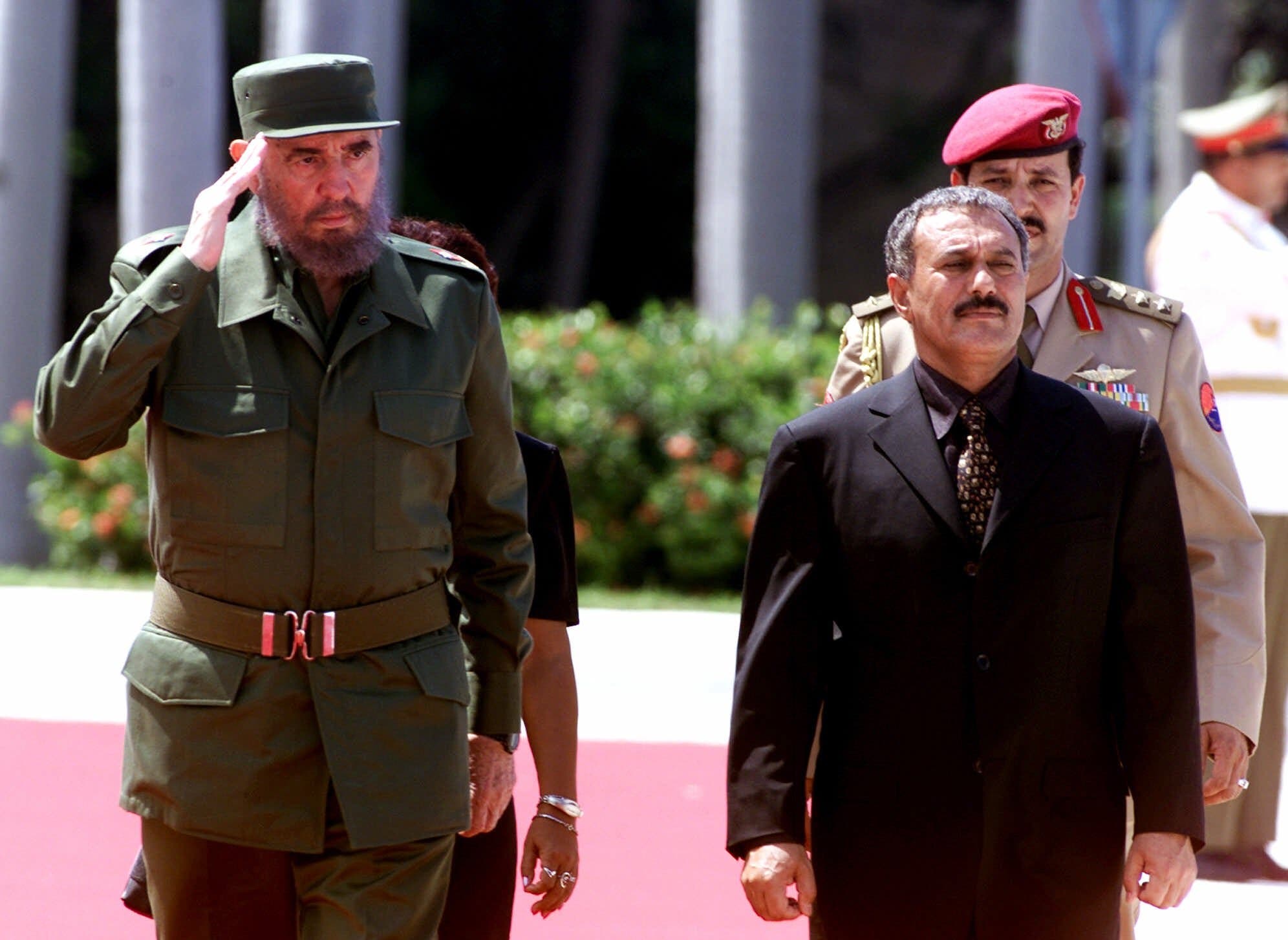 Cuban President Fidel Castro, left, and Ali Abdullah Saleh, president of Yemen, salute a military parade Tuesday Sept.12, 2000, during an official welcome ceremony as Ali Abdullah Saleh starts a 2 days visit to Cuba. (AP)