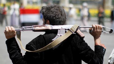 An armed man loyal to the Houthi movement holds his weapon as he gathers to protest against the Saudi-backed exiled government deciding to cut off the Yemeni central bank from the outside world, in the capital Sanaa, Yemen August 25, 2016. REUTERS/
