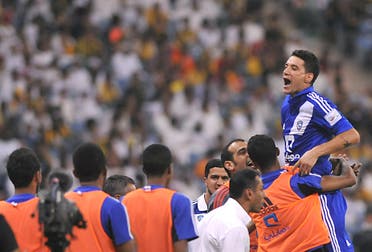 Saudi's Al-Hilal player Thiago Neves (R) celebrates with teammates after scoring against Al-Ittihad team during their Saudi Professional League football match at the King Fahad stadium in the capital of Riyadh, on September 20, 2013. AFP PHOTO/FAYEZ NURELDINE