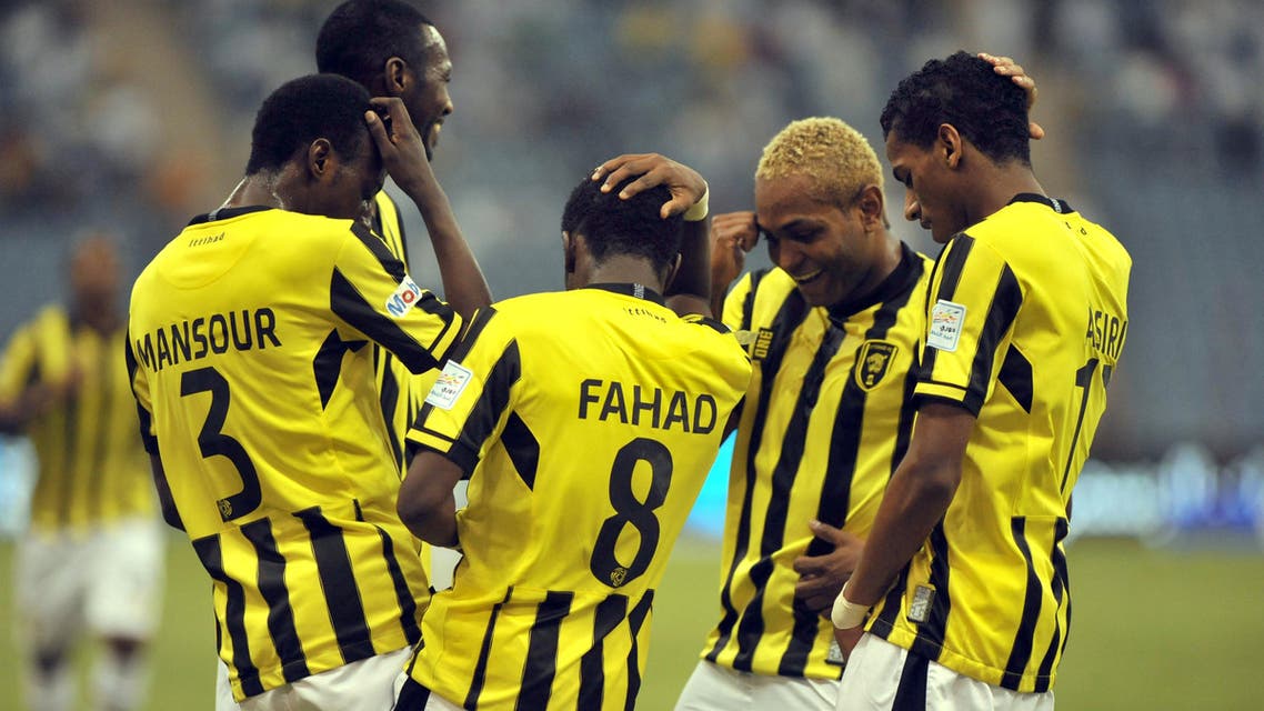 Saudi Al Ittihad's players celebrate after scoring against Al-Hilal's team during their Saudi Professional League football match at the King Fahad stadium in the capital of Riyadh, on September 20, 2013. AFP PHOTO/FAYEZ NURELDINE