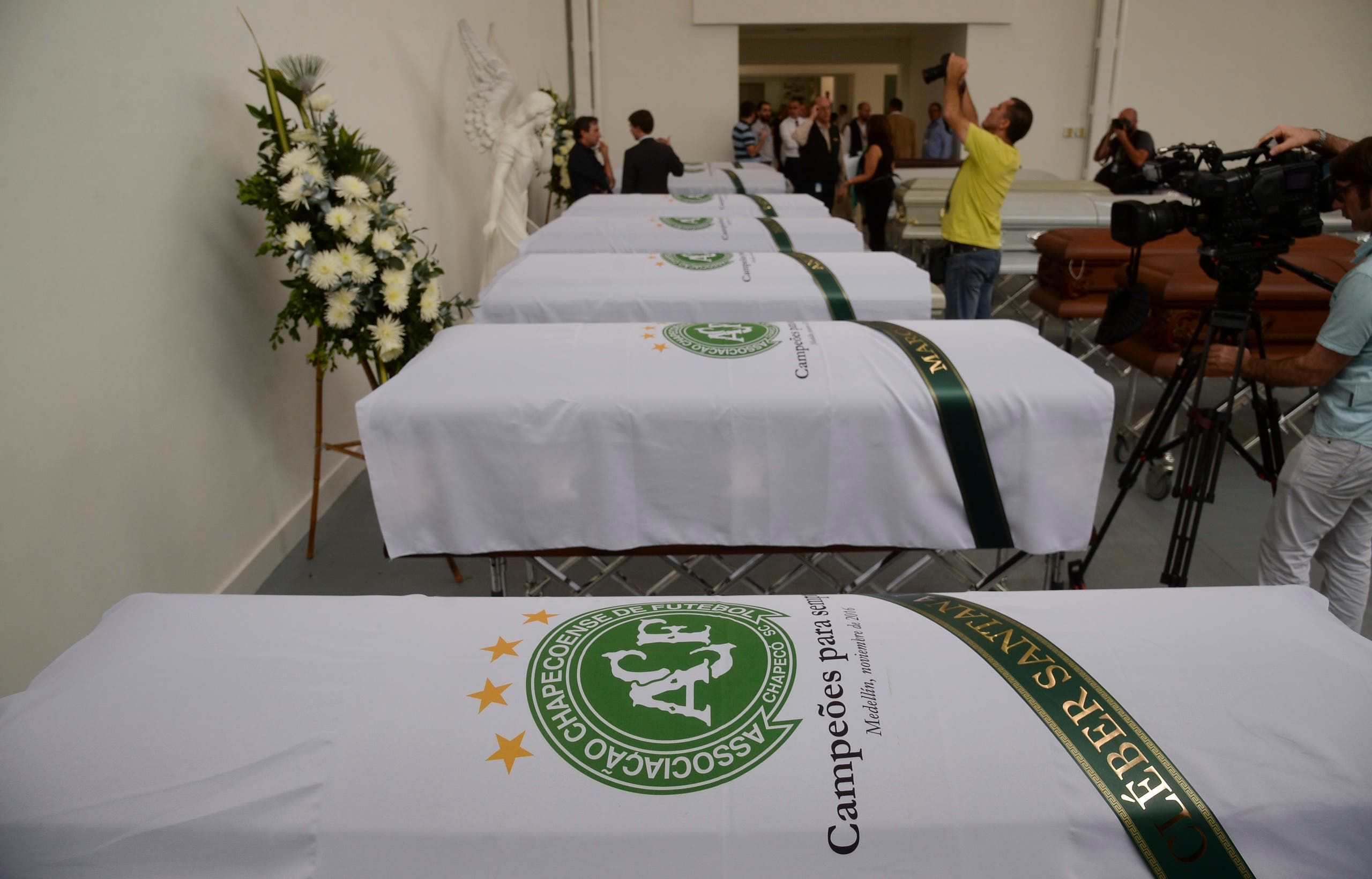 The coffin containing the remains of Brazilian football team Chapecoense Real's players Cleber Santana (foreground), killed in a plane crash in the Colombian mountains, is seen at the San Vicente mortuary in Medellin on December 1, 2016. The pilot of a charter plane carrying the Brazilian football team Chapecoense Real radioed frantically that he was out of fuel minutes before slamming into a hillside near Medellin with 77 people on board, an audio recording showed. Raul ARBOLEDA / AFP