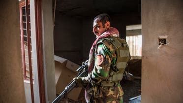 A Peshmerga fighter looks for hostiles as he and his team move between buildings in Bashiqa on November 9, 2016 Iraqi Kurdish forces have seized the town of Bashiqa near Mosul from the Islamic State group, an official said, as US-backed militia forces advanced on the jihadists' Syrian stronghold Raqa. Capturing Bashiqa would be a final step in securing the eastern approaches to Mosul, three weeks into an offensive by Iraqi forces to retake the country's second city.  Odd ANDERSEN / AFP