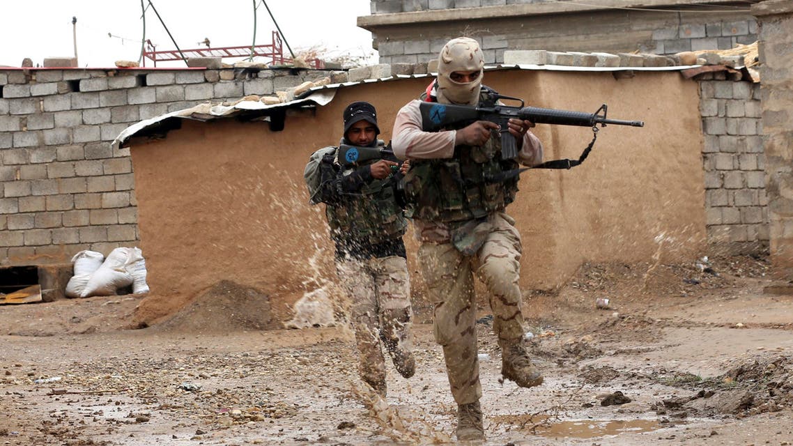 Iraqi Army soldiers secure streets in a recently liberated village occupied by Islamic State militants outside Mosul, Iraq, Thursday, Dec. 1, 2016. (AP Photo/Hadi Mizban)