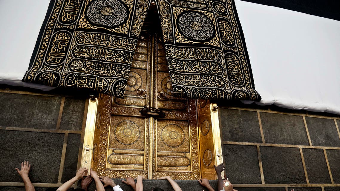 Muslim pilgrims touch the golden door of the Kaaba, Islam's holiest shrine, at the Grand Mosque in the Muslim holy city of Mecca, Saudi Arabia, Wednesday, Sept. 7, 2016. Millions of pilgrims have arrived to Mecca ahead of the Hajj annual pilgrimage which begins Saturday, Sept. 10, 2016. (AP)