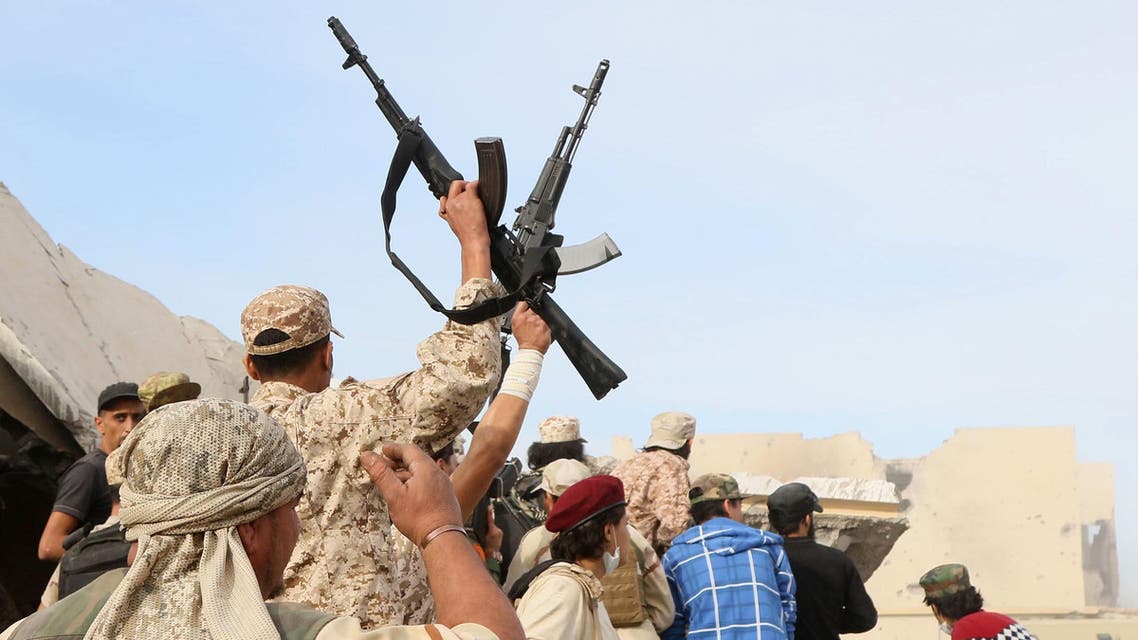 Forces loyal to Libya's Government of National Accord (GNA) brandish their weapons as they stand on the rubble of destroyed buildings in Sirte's Al-Giza Al-Bahriya district on November 21, 2016, during clashes with Islamic State (IS) group jihadists to retake control of the Mediterranean coastal city. AFP