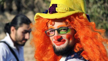 This undated photo courtesy of Ahmad al-Khatib, a media activist in Aleppo, shows Syrian social worker Anas al-Basha, 24, dressed as a clown, distributing toys to children in Aleppo, Syria. AP 