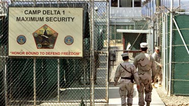 In this June 27, 2006 file photo, reviewed by a U.S. Department of Defense official, U.S. military guards walk within Camp Delta military-run prison, at the Guantanamo Bay U.S. Naval Base, Cuba. AP
