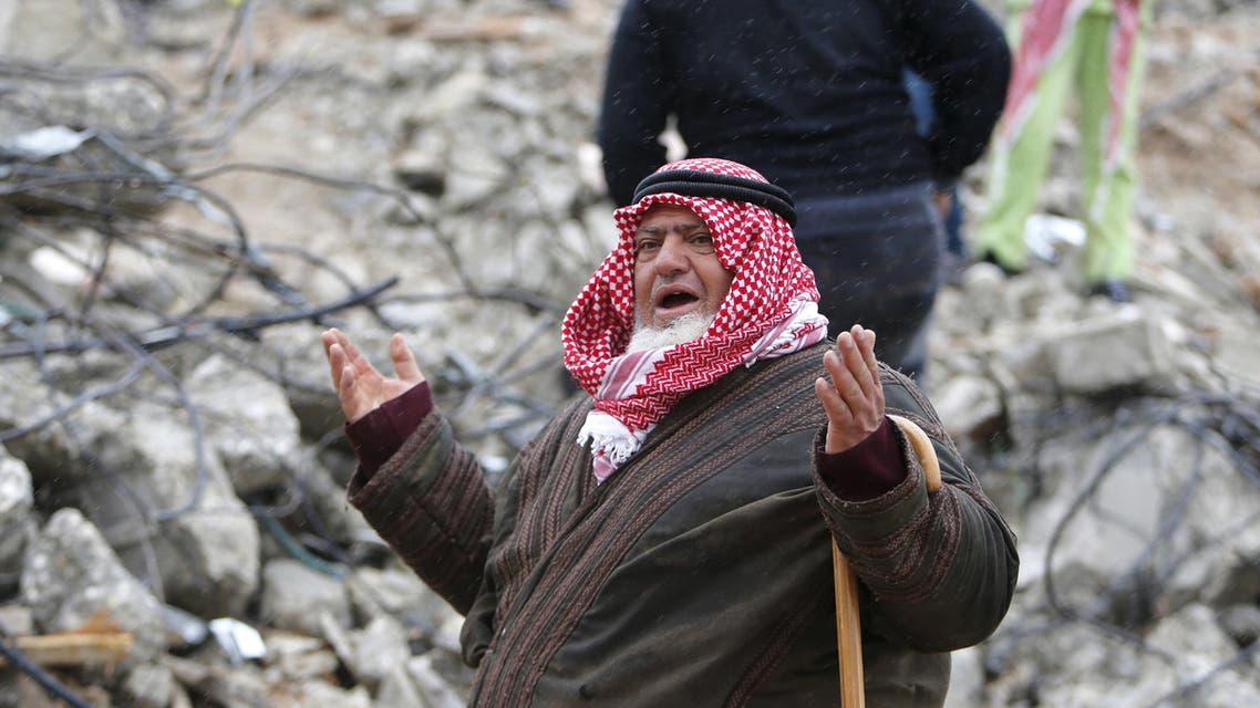 A Palestinian man gestures as he talks to the media on the rubble of of Palestinian Raed Masalmeh's home after it was demolished by Israeli army in the West Bank town of Dura, south of Hebron February 23, 2016. reuters