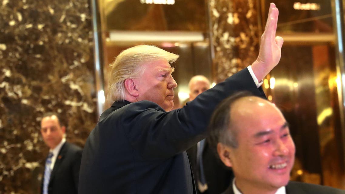 NEW YORK, NY - DECEMBER 06: President-elect Donald Trump pauses to briefly speak to the media at Trump Tower on December 6, 2016 in New York City. Trump announced that Masayoshi Son, CEO of SoftBank, has agreed to invest $50 billion in the United States and create 50,000 new jobs. Spencer Platt/Getty Images/AFP