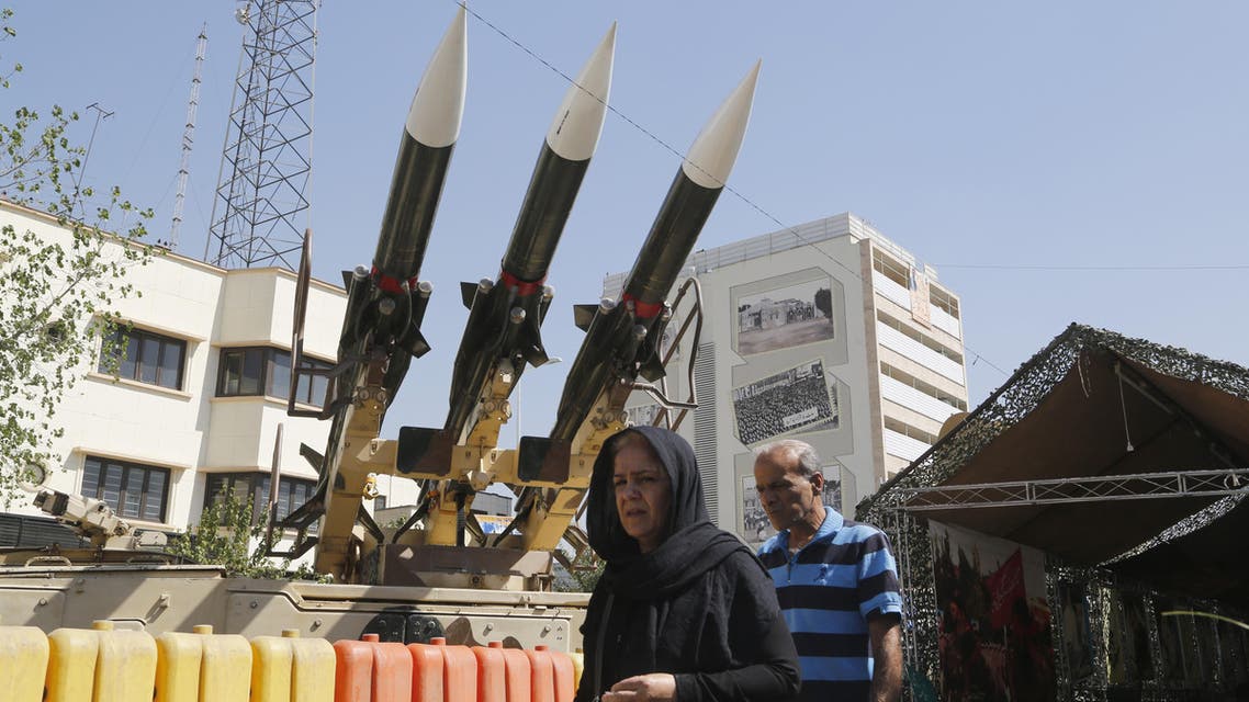 Iranians walk past Sam-6 missiles displayed in the street during a war exhibition to commemorate the 1980-88 Iran-Iraq war at Baharestan square, south of Tehran on September 26, 2016. ATTA KENARE / AFP