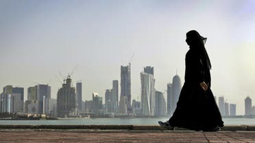 In this May 14, 2010 file photo, a Qatari woman walks in front of the city skyline in Doha, Qatar. ap