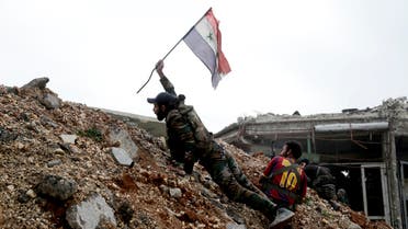  A Syrian army soldier places a Syrian national flag during a battle with rebel fighters at the Ramouseh front line, east of Aleppo, Syria, Monday, Dec. 5, 2016. The government seized large swathes of the Aleppo enclave under rebel control since 2012 in the offensive that began last week. The fighting was most intense Monday near the dividing line between east and west Aleppo as government and allied troops push their way from the eastern flank, reaching within less than a kilometer (half a mile) from the citadel that anchors the center of the city. (AP Photo/Hassan Ammar)