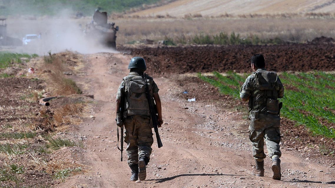Turkish soldiers patrol near the border with Syria, ouside the village of Elbeyli, east of the town of Kilis, southeastern Turkey, Friday, July 24, 2015.