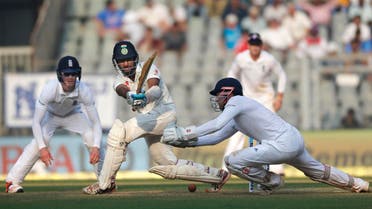 Indian batsman Cheteshwar Pujara, second from left, bats on the second day of the fourth cricket test match between India and England in Mumbai, India, Friday, Dec. 9, 2016. (AP Photo/Rafiq Maqbool)