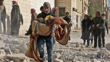 Syrian civil defence volunteers, known as the White Helmets, rescue a boy from the rubble following a reported barrel bomb attack on the Bab al-Nairab neighbourhood of the northern Syrian city of Aleppo on November 24, 2016.  AMEER ALHALBI / AFP