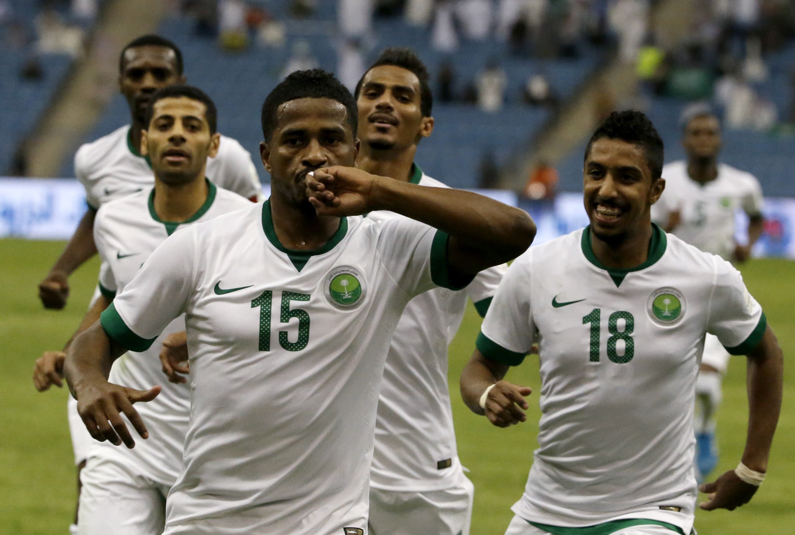 Saudi player Nasser al-Shamrani (C) celebrates with teammates after scoring a goal against Bahrain during their Gulf Cup Group A football match at the King Fahad International Stadium in Riyadh on November 16, 2014. AFP 