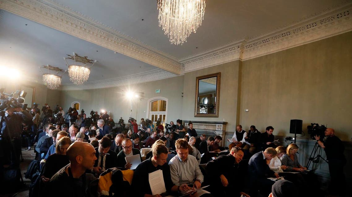 Journalists wait for the World Anti-Doping Agency investigator Richard McLaren to speak at a press conference in London, Friday Dec. 9, 2016. A new report into systematic Russian doping details a wide-ranging "institutional conspiracy" that involved more than 1,000 athletes across more than 30 sports, including evidence corroborating large-scale sample swapping at the 2014 Sochi Winter Olympics. (AP Photo/Kirsty Wigglesworth)
