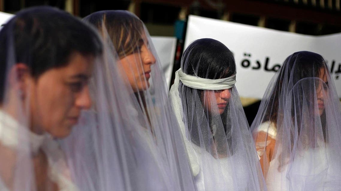 Many Lebanese women, dressed as brides in white wedding dresses stained with fake blood and bandages, gathered last week outside government buildings in Lebanon’s capital to protest against the law. (AP)