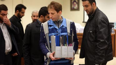 A picture made available on March 6, 2016 shows Iran's billionaire tycoon Babak Zanjani (C) in a court, in Tehran. The 41-year-old was convicted of fraud and economic crimes and as well as facing the death penalty he must repay money to the state, judiciary spokesman Gholam Hossein Mohseni-Ejeie said at his weekly press conference. Tasnim News / AFP