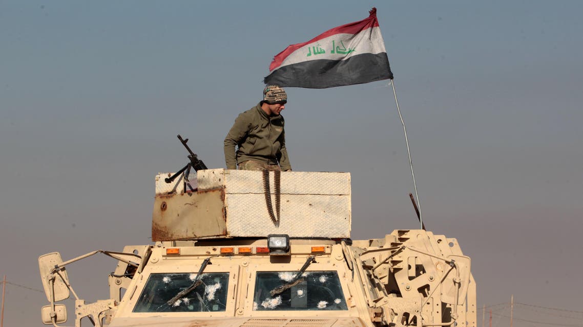 An Iraqi soldier stands atop an armoured vehicle in the town of Tal Abtah, south of Tal Afar, on December 10, 2016, after they retook the area during a broad offencive to retake the city of Mosul from Islamic State (IS) jihadists. Hashed al-Shaabi (Popular Mobilisation) paramilitary forces have made progress in recent weeks on a western front targeting Tal Afar town on the road linking Mosul to Syria. On December 8, 2016, the paramilitary forces were clearing Tal Abtah of bombs and booby traps after a fierce, days-long fight to retake it. AHMAD AL-RUBAYE / AFP